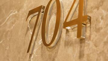 A close-up of a marble wall with the number '704' prominently displayed.