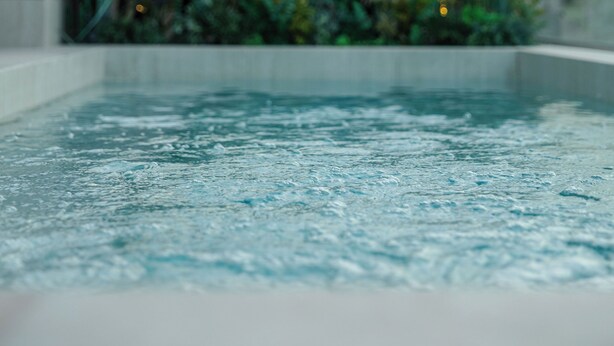 An indoor pool with a view of a building with a dome in the background. - LOS 36 BY GRUPO CCOMMO (Murcia)