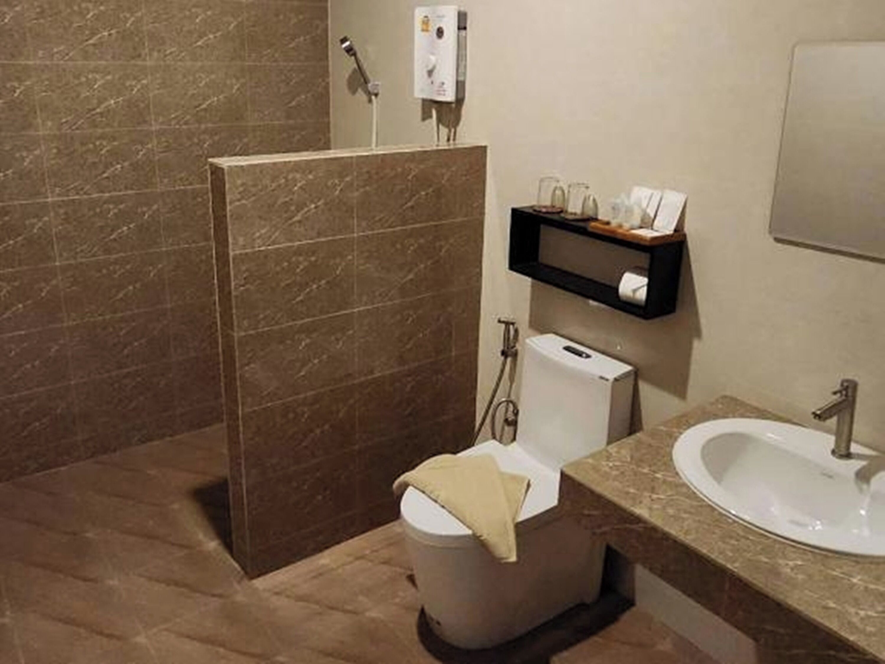 A bathroom with a shower, toilet, and sink.
