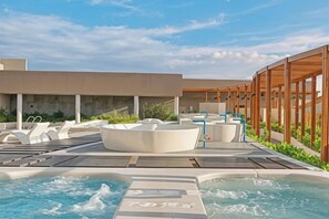 A rooftop pool area with hot tubs and lounge chairs. - Bliss Driftwood Retreat By Mandala (Phan Thiet)