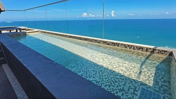 On peut admirer une piscine aux carreaux décoratifs, avec une vue dégagée sur l’océan.