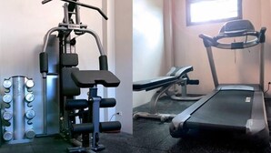 A gym with a stationary bike, a bench press, and a weight stack. - Eco Villa, Sea View, Lamai Koh Samui (Koh Samui)