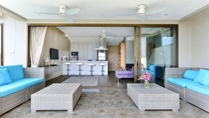 A modern living room with two sofas, a coffee table, and a kitchen area in the background. - Eco Villa, Sea View, Lamai Koh Samui (Koh Samui)