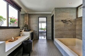 A modern bathroom with a large bathtub, a vanity with a sink, and a window providing natural light. - Eco Villa, Sea View, Lamai Koh Samui (Koh Samui)
