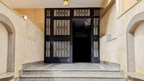 A set of marble steps leading to a black gate with decorative metalwork. - RD The Residence Serviced Apartment, New Cairo Prime Location (New Cairo City)