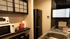 A compact kitchen with a microwave, coffee maker, and a black refrigerator. - [Family-Friendly] Kyoto House, Walk to Gion (Kyoto)