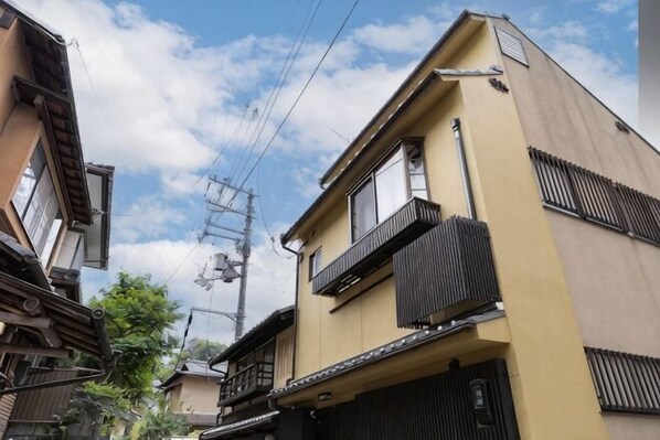 A multi-story building with a flat roof, a balcony on the second floor, and a visible entrance. - [Family-Friendly] Kyoto House, Walk to Gion (Kyoto)