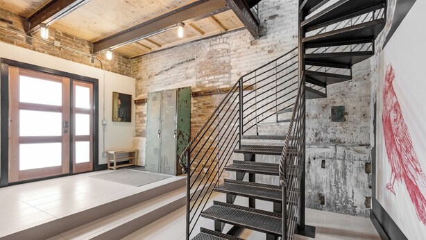 A modern interior with a staircase, a bench, and a door leading to another room. - Downtown•Near River, Trails & Shopping (Salida)