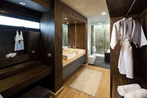 A modern bathroom with wooden walls, a large mirror, dual sinks, a shower area, and a robe hanging on a rack. - Prime Deluxe Villa No. V17 (Sattahip)
