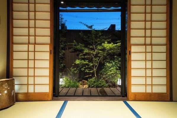 A traditional Japanese room with tatami flooring and shoji screens.