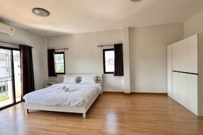 A bedroom with a bed, a wardrobe, and a window. - Elly's Home. Convenience & Serenity (Chiang Mai)