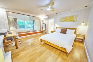 A bedroom with a bed, desk, chair, and a window with blinds. - JT_TEVA (USD) (Seoul)