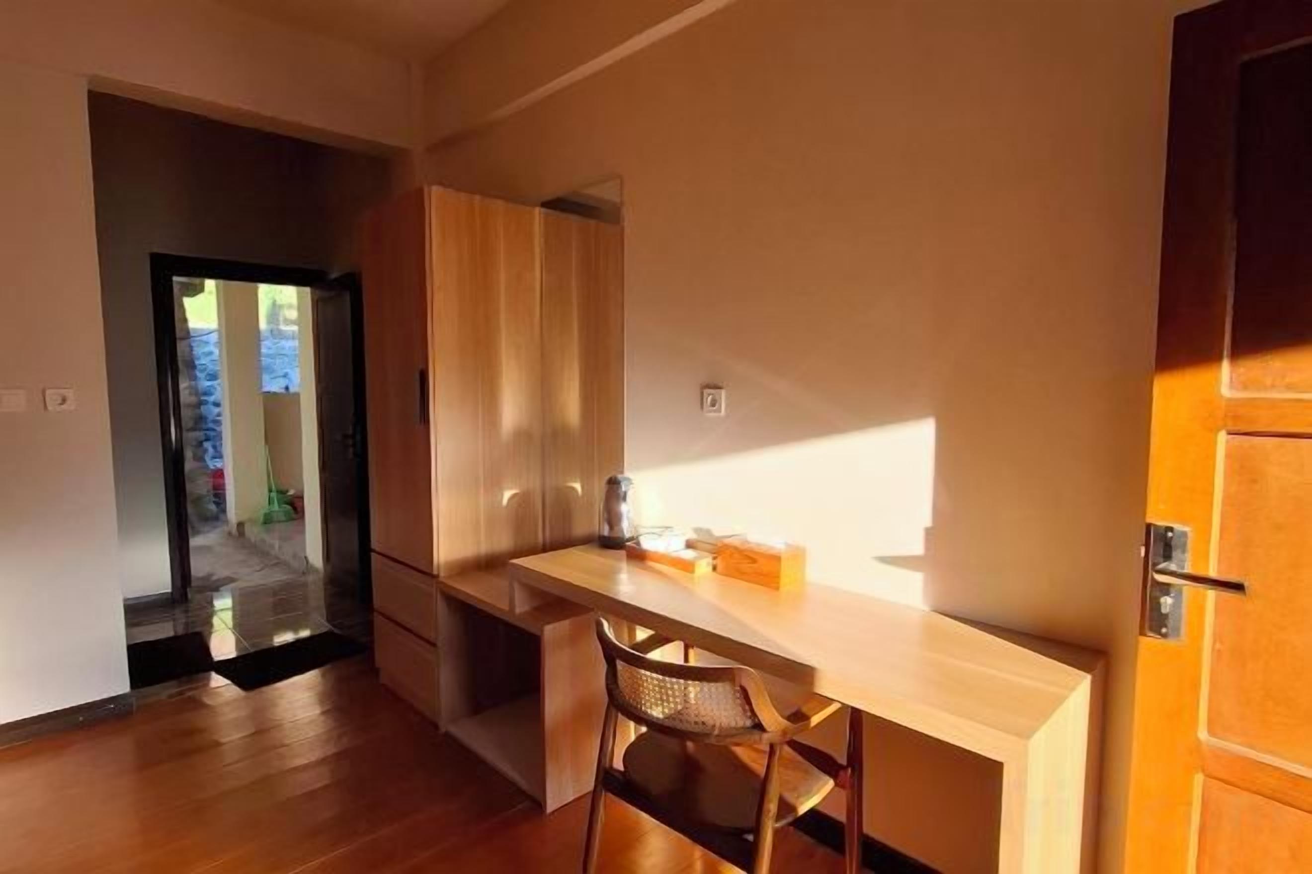 A kitchen with a wooden countertop, a chair, and a cabinet.