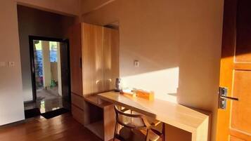 A kitchen with a wooden countertop, a chair, and a cabinet.