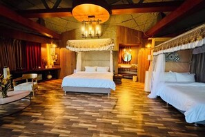 A spacious bedroom with a large bed, a bedside table, and a chair.
