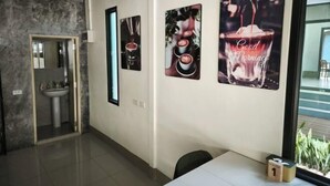 A modern hotel room with a large window, a sink, and three framed pictures on the wall. - The Secret Garden Homestay Koh yao yai (Koh Yao Yai)