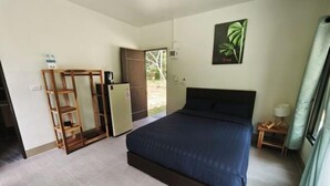 A bedroom with a bed, a wardrobe, a desk, and a door leading outside. - The Secret Garden Homestay Koh yao yai (Koh Yao Yai)