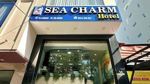 The Sea Charm Hotel facade with a clear entrance, a signboard, and a visible address. - Sea Charm Hotel (Da Nang)