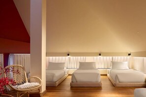 A hotel room with a high ceiling, three beds, a wicker chair, and a window with curtains. - Mahi-Mahi Beachfront Villa by Yudee Assets (Tha Yang)
