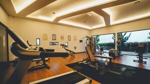 A modern gym with exercise equipment, large windows, and a wooden floor. - Marina Residence 3BR Shores Haven nr Midvalley CIQ (Plentong)
