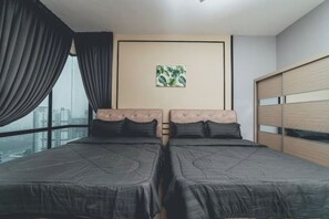 A bedroom with two beds, a city view, a framed plant, and a wardrobe. - Marina Residence 3BR Shores Haven nr Midvalley CIQ (Plentong)