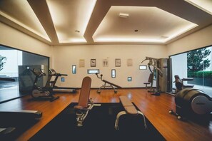 A gym with exercise equipment, a large mirror, and a view of the outdoors. - Marina Residence 3BR Shores Haven nr Midvalley CIQ (Plentong)