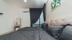 A bedroom with a large bed, a bedside table, a mirror, and a window with curtains. - Marina Residence 3BR Shores Haven nr Midvalley CIQ (Plentong)
