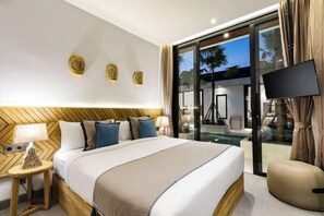 A hotel room with a large bed, a TV, a glass door leading to a balcony, and a view of palm trees. - Villa Juke by BaliSuperHost (Bali)