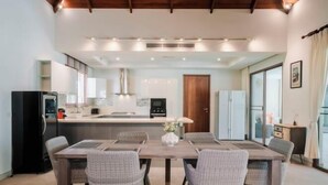 A modern kitchen with a central island, built-in appliances, and ample lighting. - Luxury 4Br Villa 5 Private Pool & Jacuzzi (Phuket)