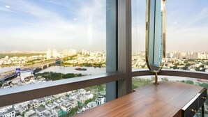 A high-rise building with a large window overlooking a cityscape, including a river and bridge. - Golden Grand Landmark (Ho Chi Minh City)