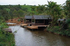 A houseboat with a dock, surrounded by water and greenery. - The Village Resort in the Painting, Bao Loc (Bao Lam District)