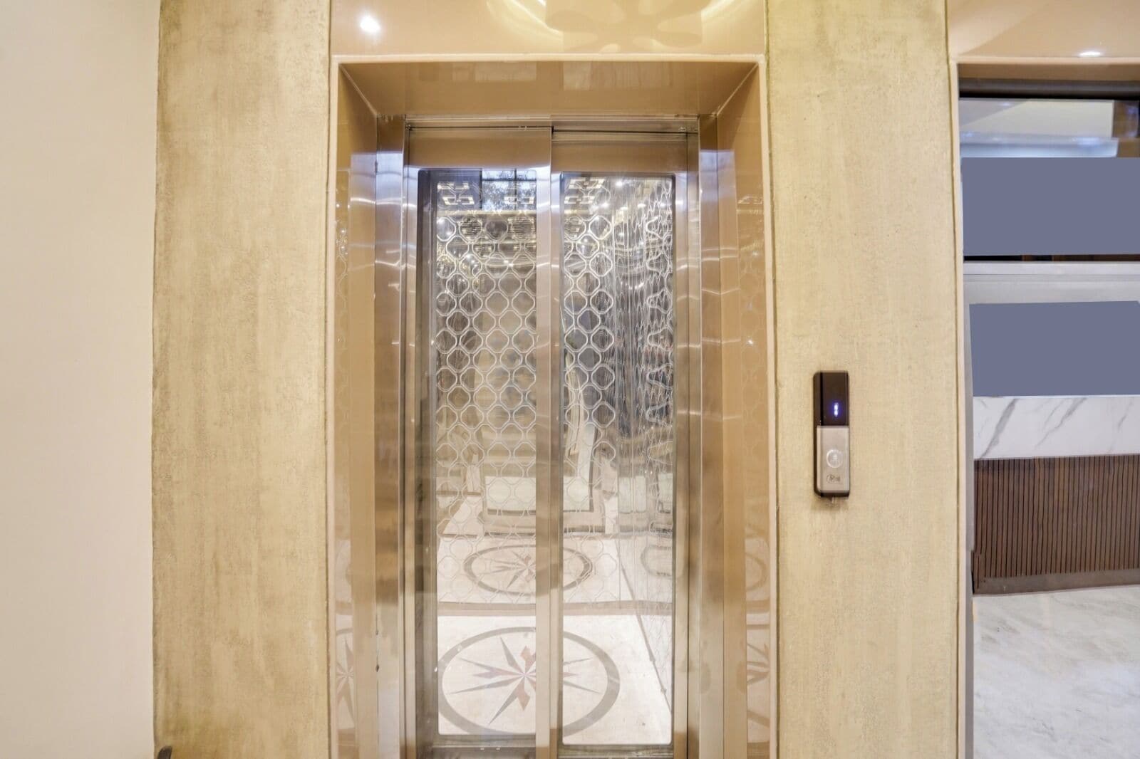 An elevator with a glass door featuring a geometric pattern.
