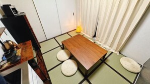 A traditional Japanese room with tatami flooring, a low wooden table, and a futon bed. - 【Color Nook1】Central Tokyo 15min／Narita 1hr！Station 10min walk！Newly renovated apartment (Tokyo)