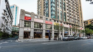 A multi-story commercial building with various storefronts, including a coffee shop and a business office. - TUXI INTERNATIONAL APARTMENT (Guangzhou)