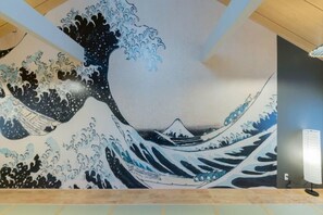 A mural of a wave with a mountain in the background. - Yadoya Negishi (Tokyo)