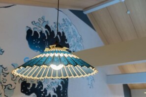 A hanging lamp with a blue and white pattern, a wooden ceiling, and a wall with a blue and white design. - Yadoya Negishi (Tokyo)