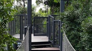 A suspension bridge with metal railings and a wooden platform, surrounded by dense greenery. - KLCity & KLCC View Modern Style 2R2B - 6 pax (Kuala Lumpur)
