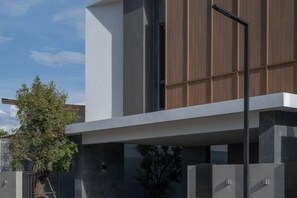 A modern building with a flat roof, large windows, and a minimalist design.