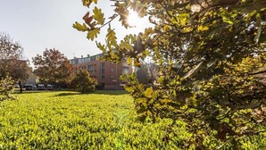 A grassy field with a building in the background.