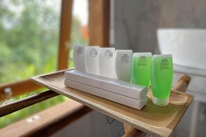 A tray with skincare products on a wooden surface near a window. - Jatiluwih Guava Eco Living Managed by Manara (Bali)