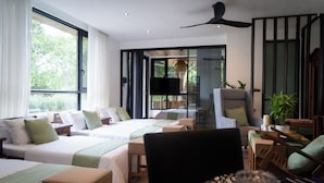 A modern hotel room with two beds, a dining area, and a large window with a view of greenery. - Your Private Villa Nestled in Nature (General Emilio Aguinaldo)