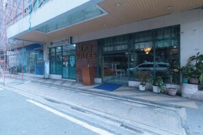 A hotel entrance with a sign for 'MPT SUITES' and a visible entrance door. - RedDoorz @ MPT Suites (Makati)