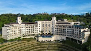 Un hotel grande de varios pisos con un patio central y dos torres destacadas.