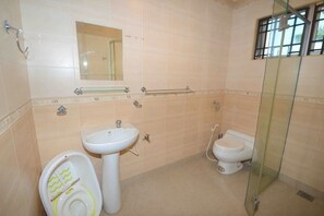 A bathroom with a toilet, sink, and glass shower enclosure. - Decozy 3.0 Semi-D (18pax++) (Ipoh)