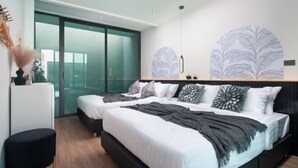 A modern bedroom with two beds, a large window, and a wall with leaf patterns. - Nacha Pool Villa Cha-am (Cha-am)