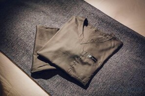 A pair of folded trousers on a textured grey carpet. - Asahi House Kyoto（Dog Friendly） (Kyoto)