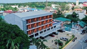 A multi-story building with a flat roof and a parking area in front. - The Manaoag Hotel (Manaoag)