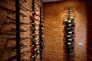 A wine rack against a brick wall with bottles arranged vertically. - Luxury Pure Modern Pool Villa 5Bed Nr BTSCentral (Bangkok)