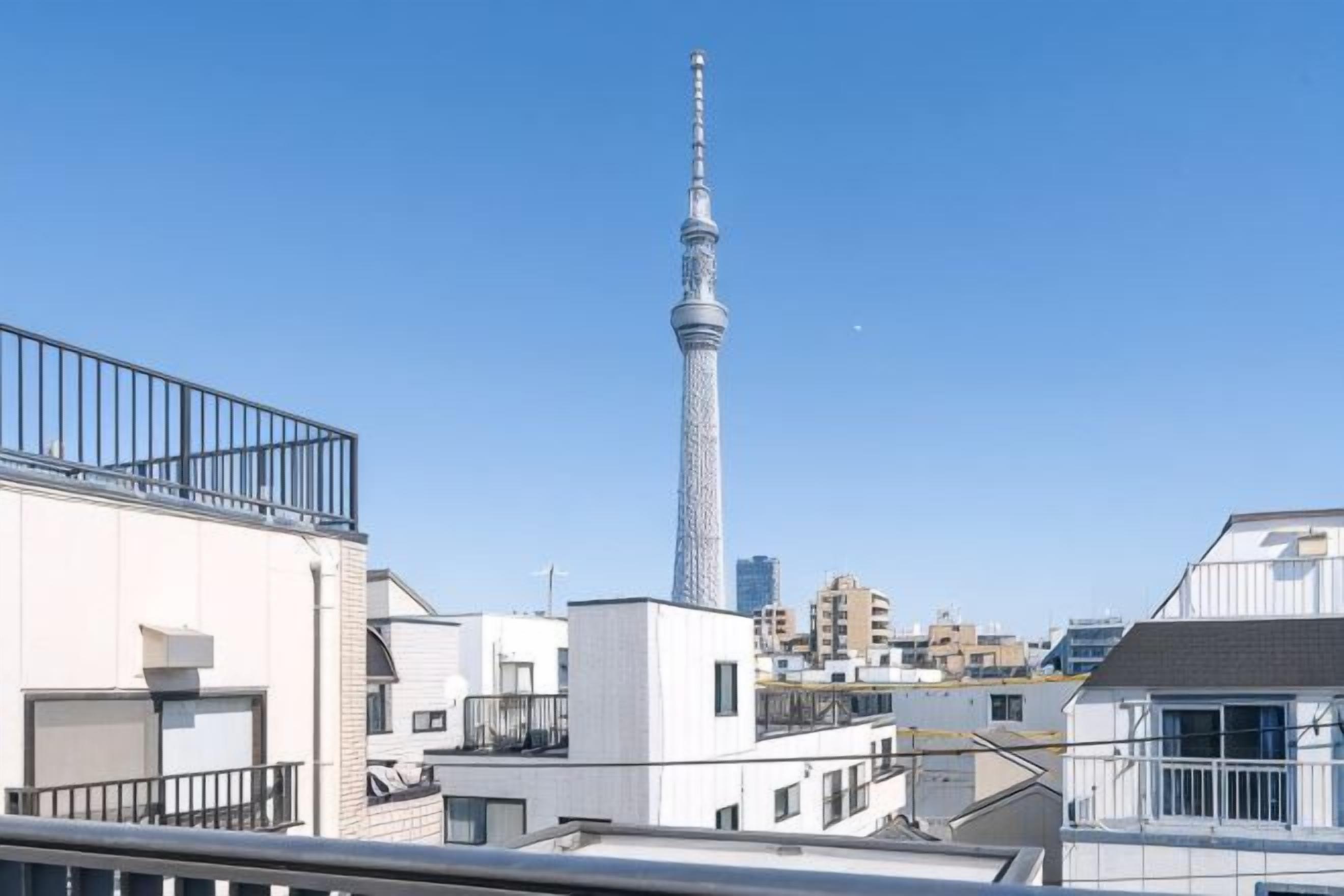 A high-rise building with a distinctive tower, surrounded by other buildings.
