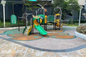 A playground with a slide and climbing structures. - 7Pax Family-Friendly Kepong DesaPark MontKiara (Kuala Lumpur)